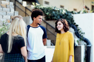 Three people smiling outside