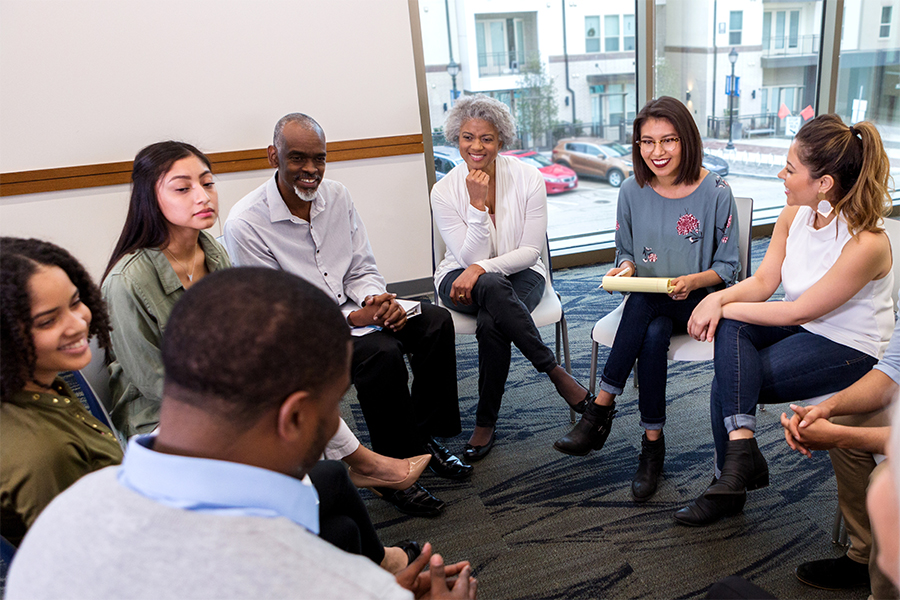 Group of people in a circle conversing